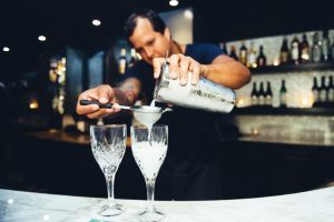 Man Pouring Cocktail At Bar