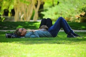 man-laying-down-in-park