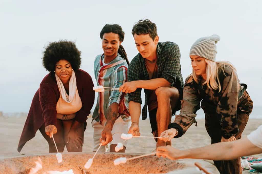 Friends-Roasting-Marshmellows-In-Front-of-Camp-Fire