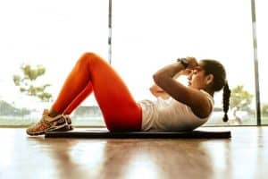 Woman Doing Crunches in Her Apartment